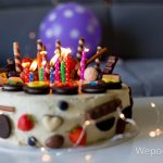 children&#39;s cake with candles and cookies